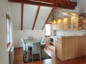 a kitchen with a table and chairs in a room at Vila Gardenia in Sarajevo