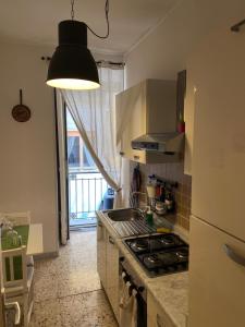 a kitchen with a sink and a stove top oven at In The Heart Of Naples in Naples