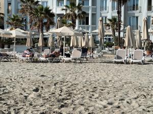 a group of people sitting in chairs on the beach at holiday house in Durrës