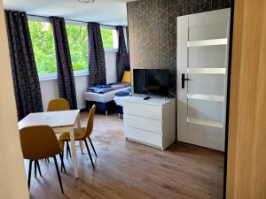 a living room with a table and a television and a dining room at Szczecin Centrum 3 in Szczecin +10 photos