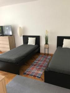 sala de estar con 2 camas y sofá en Központi apartman, en Kiskunfélegyháza