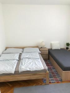 a bedroom with two beds and a mattress at Központi apartman in Kiskunfélegyháza