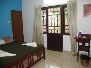 Postel nebo postele na pokoji v ubytování Lazar Residency Homestay