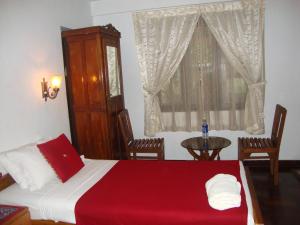 Postel nebo postele na pokoji v ubytování Lazar Residency Homestay