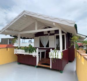 a building with awning and a table on a roof at TLT Guest Houses 