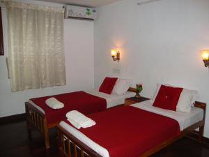 Postel nebo postele na pokoji v ubytování Lazar Residency Homestay