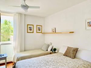 a bedroom with two beds and a window at Casa Adela /Terraza/5m playa / Aire acondicionado in Cadaqués
