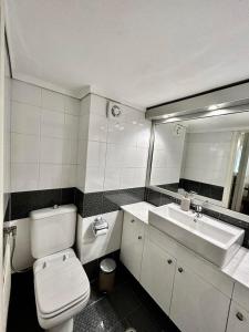 a bathroom with a toilet and a sink and a mirror at DM Villa - quality stay in Perea, Thessaloniki, Greece in Perea