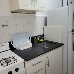 a kitchen with a sink and a white refrigerator at Palermo Botánico in Buenos Aires