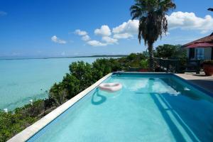 a swimming pool with a view of the ocean at Turquoise Haven Villa in Providenciales