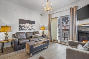 a living room with a couch and a fireplace at Newly renovated Blue Sky - Family Fun - 2 Bed -2 Bath in Canmore