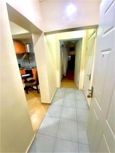 a hallway with a white door and a living room at Apartment A- 2 Bedroom Apartment) Hillside Gardens in Lagos