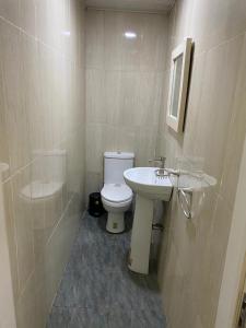 a bathroom with a toilet and a sink at Apartment A- 2 Bedroom Apartment) Hillside Gardens in Lagos