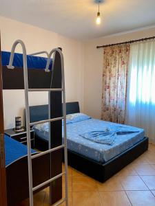 a bedroom with two bunk beds and a window at Rayde Apartments in Golem