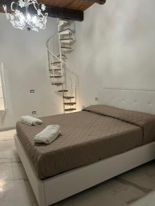 a bedroom with a bed and a spiral staircase at B&B bella vista in Pizzo