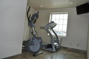 a gym with two exercise bikes in a room at Boarders Inn & Suites by Cobblestone Hotels - Broken Bow in Broken Bow