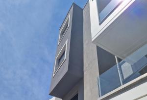 a view of the side of a building with windows at Volos Terra Deluxe Residences in Volos