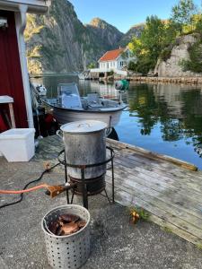 a bucket sitting on a dock next to a boat at Reistad Ranch in Hidra
