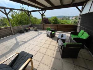 a patio with couches and chairs and a table at Apartments Marienburg in Nordstemmen