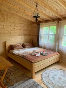 a bedroom with a large bed in a log cabin at BUNGALOV in Kemer
