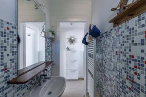 a bathroom with a sink and a mirror at Sissi's Home [Due Passi Dal Mare, Free WiFi] in Punta Marina