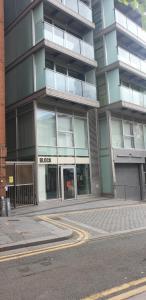 a large glass building with a street in front of it at Pettit Apartments - Central "Free Parking" in Liverpool