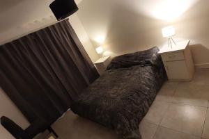 a bedroom with a bed with a curtain and a night stand at Casa Otarina Chapadmalal in Chapadmalal +30 photos