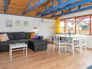 a living room with a couch and a table at 6 person holiday home in Juelsminde-By Traum in Sønderby