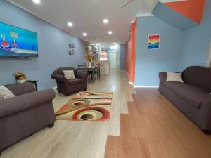 a living room with two couches and a table at Chez Moi in Castries