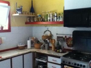 a kitchen with a stove and a counter top at Spacious, Sunny, Cozy & Secure in Mindelo