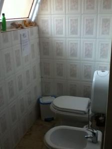 a small bathroom with a toilet and a window at Spacious, Sunny, Cozy & Secure in Mindelo