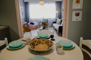 a dining room table with blue and white dishes on it at Forget Me Not in Kavála