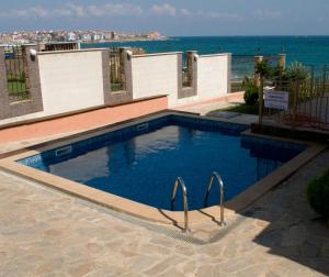 a swimming pool with the ocean in the background at Barex Family Hotel in Sozopol