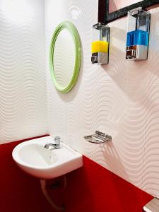 a bathroom with a sink and a mirror at Benheal Homestay in Cochin