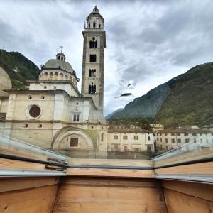 a book with a picture of a building with a clock tower at Altavilla Albergo meublé in Tirano