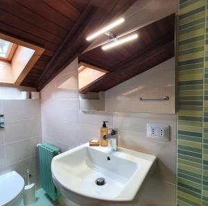 a bathroom with a white sink and a toilet at Altavilla Albergo meublé in Tirano