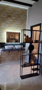 a room with a bed and a mirror at Boutique Suites in Arcos de la Frontera