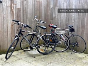 dos bicicletas estacionadas junto a una valla de madera en Casper House, Near Maastricht, en Lanaken