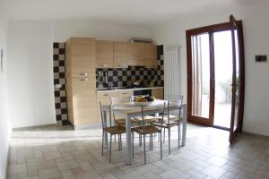a kitchen with a table and chairs in a room at Residenza La Mannara in Itri