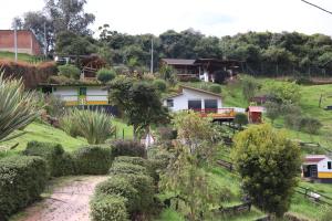 vistas a la casa desde el jardín en Glamping en Granja Campo Hermoso, en Cogua
