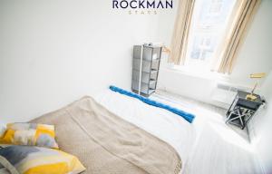 een slaapkamer met een bed en een raam bij 12B Alexandra Street - Stylish Apartment in the Heart of Southend on Sea by Rockman Stays in Southend-on-Sea