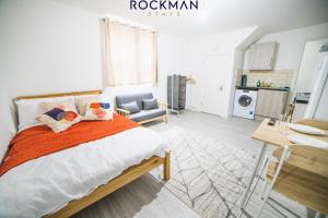 a bedroom with a bed and a desk and a chair at 12D Alexandra Street - Charming Apartment in Central Southend Location by Rockman Stays in Southend-on-Sea