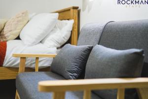 un divano con cuscini accanto a un letto di 12D Alexandra Street - Charming Apartment in Central Southend Location by Rockman Stays a Southend-on-Sea