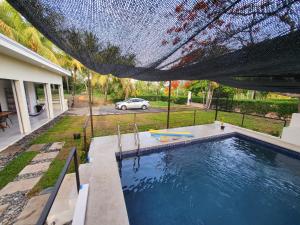 an overhead view of a swimming pool in a house at Villa Elenita - Sol y Calor ! in Parrita