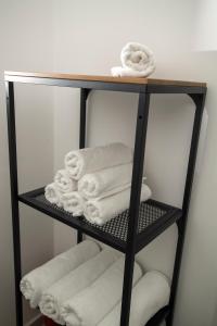 a black towel rack with white towels on it at GOLANI8 in Haifa