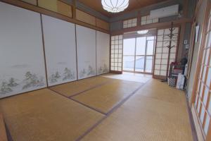 an empty room with a large window in a building at I Osaka Traditional in Osaka