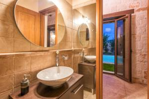 a bathroom with a sink and a mirror at Astarte Villas - Kyveli Luxurious Private Villa in Zakynthos Town +19 photos