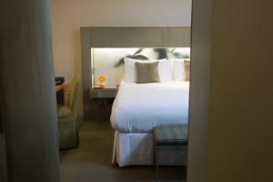 a bedroom with a large bed and a mirror at Shoreham Hotel in New York