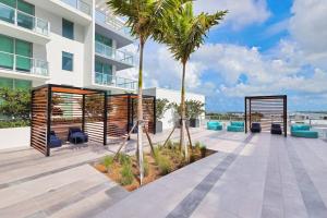 a patio with palm trees in front of a building at Miami design district, view of the bay - city in Miami