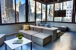 a living room with a couch and a table and windows at Shoreham Hotel in New York